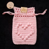 Pochette à bijoux en coton, avec fermeture par lanières coulissantes.